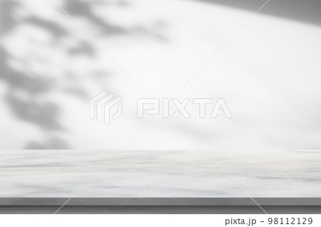 Marble table with tree shadow drop on white wall background for mockup product display 98112129