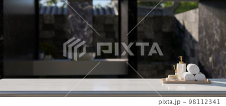 Empty space on white tabletop with bath accessories over blurred modern outdoor bathroom. Empty space on white tabletop with bath accessories over blurred modern outdoor bathroom. 98112341