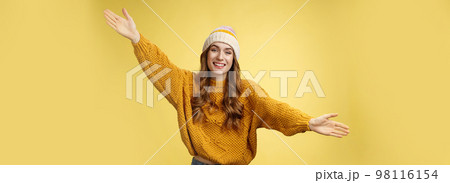 Friendly happy charming smiling cute girl inviting friends joyfully spread hands embracing wanna hug cuddle dear guest grinning cheerful, having fun expressing postivity good mood 98116154