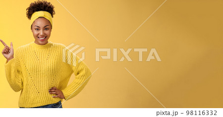 Charming sassy stylish african-american girl in sweater pointing upper left corner standing confident cheeky energized smile yellow background promoting merch showing best choice look camera amused Charming sassy stylish african-american girl in sweater pointing upper left corner standing confident cheeky energized smile yellow background promoting merch showing best choice look camera amused 98116332