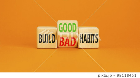 Build good or bad habits symbol. Concept word Build good or bad habits on wooden cubes. Beautiful orange table orange background. Business and build good or bad habits concept. Copy space. 98118451