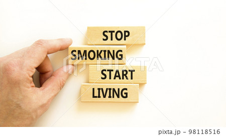Stop smoking start living symbol. Concept words Stop smoking start living on cubes. Beautiful white background. Doctor hand. Medical healthy lifestyle stop smoking start living concept. Copy space. 98118516