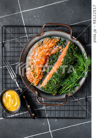 Pickled Salmon fillet with dill, salt and papper, gravlax. Black background. Top view Pickled Salmon fillet with dill, salt and papper, gravlax. Black background. Top view 98122017