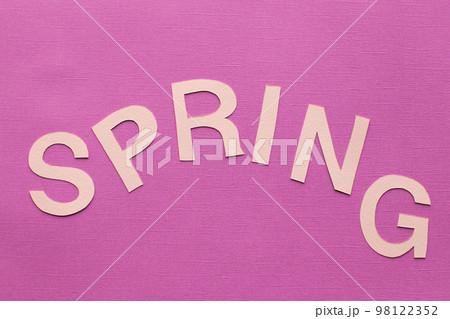 Text spring cut out of paper on a pink background. Text spring cut out of paper on a pink background. 98122352