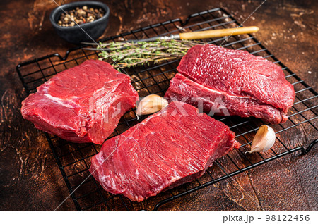 Raw Wild Game Meat of Venison dear ready for cooking. Dark background. Top view 98122456
