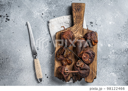 Sun Dried persimmon fruit on wooden board. Gray background. Top view 98122466