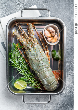 Fresh Raw Spiny lobster or sea crayfish ready for cooking. White background. Top view Fresh Raw Spiny lobster or sea crayfish ready for cooking. White background. Top view 98122513