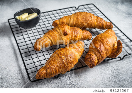 Baked Croissants on a cooling rack. White background. Top view 98122567