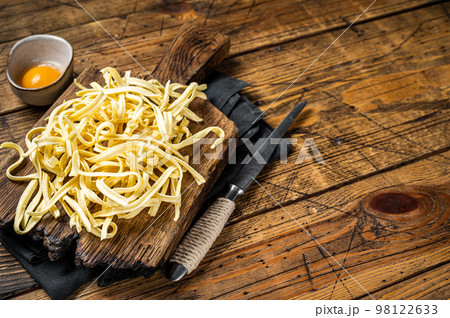 Cooking raw spaetzle egg noodle. Wooden background. Top view. Copy space 98122633