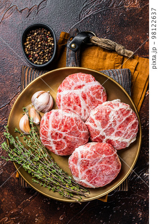 Raw french meatballs cutlet with spices and herbs. Dark background. Top view 98122637