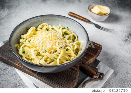 Spaetzle German egg noodles with cheese served with parsley. White background. Top view 98122730