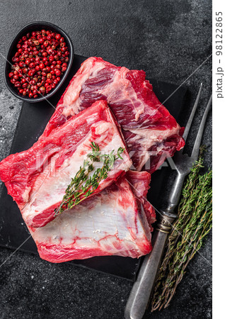 Veal beef Short Ribs, raw sparerib on marble board. Black background. Top view Veal beef Short Ribs, raw sparerib on marble board. Black background. Top view 98122865
