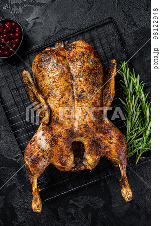 Roast whole duck, festive christmas recipe. Black background. Top view Roast whole duck, festive christmas recipe. Black background. Top view 98122948