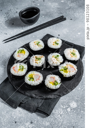 Korean style sushi Kimbap or gimbap made from steamed white rice. Gray background. Top view 98123108