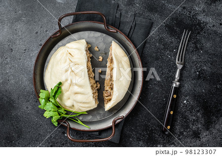 National Korean fast food - steamed pies pyan-se Pyanse with vegetable and meat. Black background. Top view 98123307
