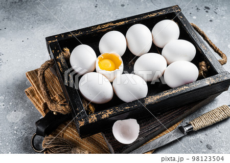 Box with organic farm white chicken eggs. Gray background. Top view 98123504