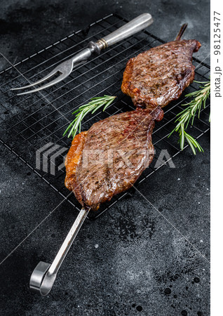 Picanha, traditional Brazilian barbecue, grilled beef meat steak. Black background. Top view 98125477