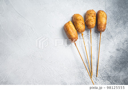 Homemade deep fried corn dogs. White background. Top view. Copy space Homemade deep fried corn dogs. White background. Top view. Copy space 98125555