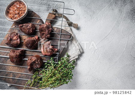 BBQ Grilled lamb mutton kidney, offal meat on grill. White background. Top view. Copy space BBQ Grilled lamb mutton kidney, offal meat on grill. White background. Top view. Copy space 98125842