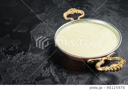 Vichyssoise French cream soup with leek, potato and onion. Black background. Top view. Copy space Vichyssoise French cream soup with leek, potato and onion. Black background. Top view. Copy space 98125978