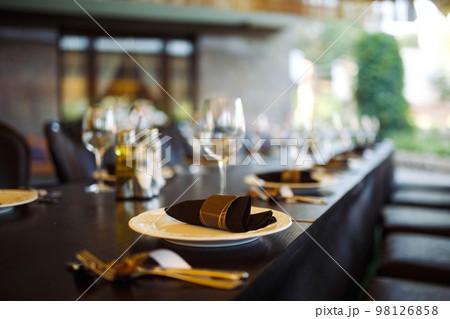 Sparkling glassware stands on long table prepared for wedding dinner. 98126858