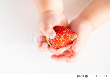 苺を持つ乳児の手。 98126871