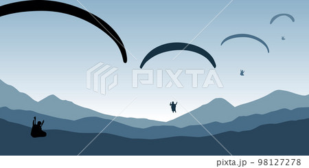 paragliding adventure flying with friends on blue mountain background at sunset paragliding adventure flying with friends on blue mountain background at sunset 98127278