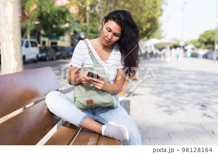 Woman with smartphone in park 98128164