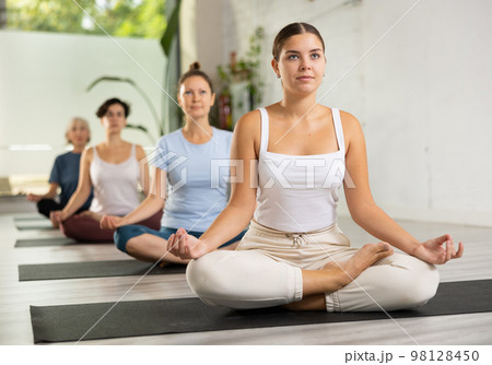 Group of woman making yoga meditation in lotus pose 98128450