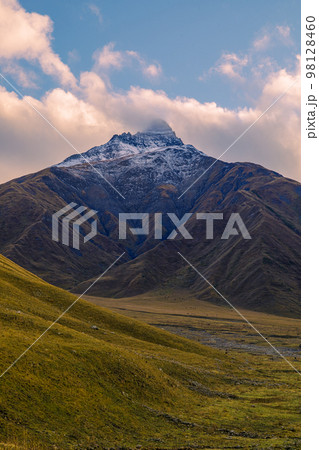 Highlands of North Ossetia. Mountains of the Caucasus. High mountains in the rays of the setting sun. Highlands of North Ossetia. Mountains of the Caucasus. High mountains in the rays of the setting sun. 98128460