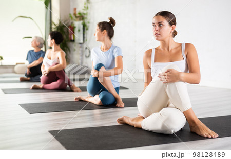 Group of sporty people practicing various yoga positions during training 98128489