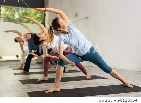 Women making yoga. Virabhadrasana pose Women making yoga. Virabhadrasana pose 98128564