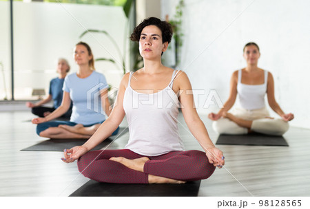Woman making yoga meditation in lotus pose 98128565