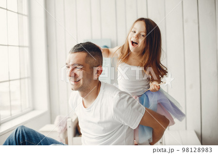 Family at home. Little girl playing with a father. 98128983