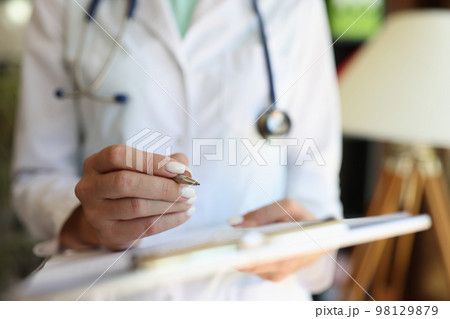 Female doctor working with medical forms and documents close-up. 98129879