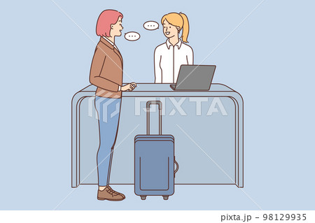 Woman with suitcase talk with administrator on reception Woman with suitcase talk with administrator on reception 98129935