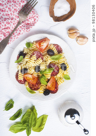 Antipasto salad with pasta, tomato, olives, red onion, bell pepper, salami Antipasto salad with pasta, tomato, olives, red onion, bell pepper, salami 98130406