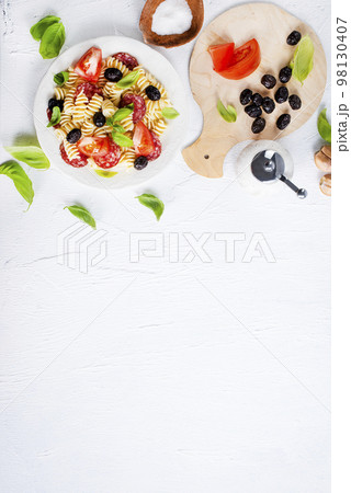 Antipasto salad with pasta, tomato, olives, red onion, bell pepper, salami Antipasto salad with pasta, tomato, olives, red onion, bell pepper, salami 98130407