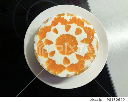 white mousse with orange slices on a platter top view 98130640