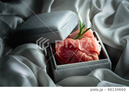 Prosciutto with rosemary in a gray gift box. 98130660