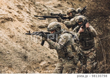 Group of soldiers with rifles before combat 98130798