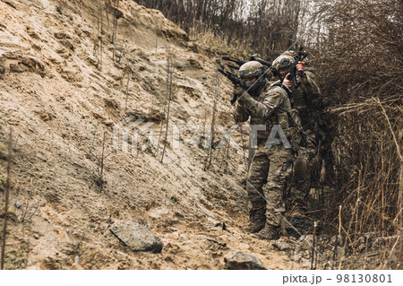 Group of soldiers with rifles before combat Group of soldiers with rifles before combat 98130801