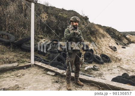 Man in military uniform and a rifle Man in military uniform and a rifle 98130857