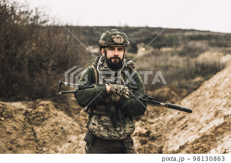 A soldier with a rifle on a shooting range A soldier with a rifle on a shooting range 98130863