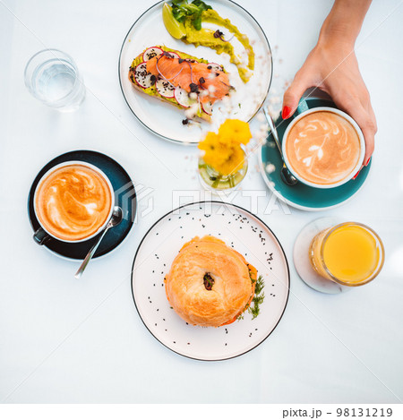 Top view of the unknown woman hand holding avocado toast Top view of the unknown woman hand holding avocado toast 98131219