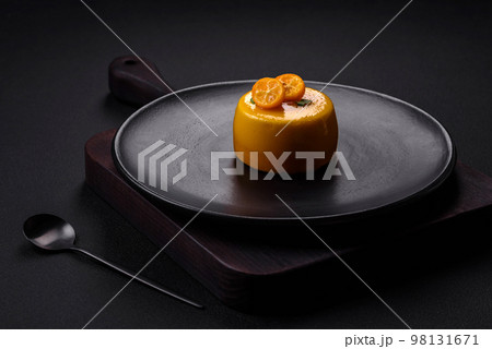 Delicious fresh tartlet with citrus filling and decorated with passion fruit 98131671
