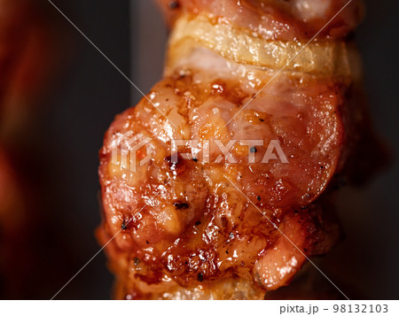 Cooking pork kebab in electrical barbecue on skewers 98132103