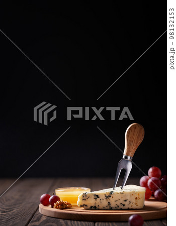 Piece of blue cheese woth fork on slatter Piece of blue cheese woth fork on slatter 98132153
