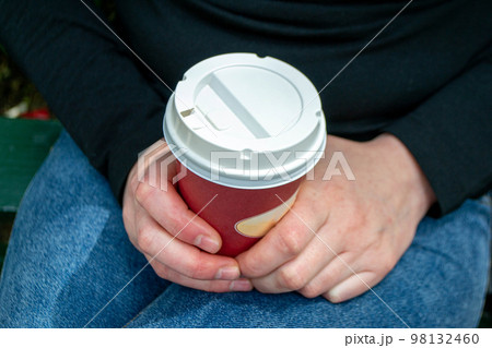 Coffee Business Concept-Female barista making coffee and serving a paper cup of hot coffee in street. High quality photo Coffee Business Concept-Female barista making coffee and serving a paper cup of hot coffee in street. High quality photo 98132460