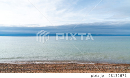 Issyk Kul Lake scenery in Kyrgyzstan. Issyk Kul is a large, high-altitude lake, known for its crystal clear waters and is a popular tourist destination in the region. 98132671